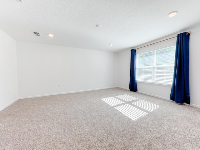 58 Eunola Ln, Freeport, FL 32439 - unfurnished room with baseboards, visible vents, light carpet, and a textured ceiling