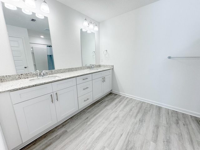 58 Eunola Ln, Freeport, FL 32439 - bathroom with wood finished floors, double vanity, and a sink