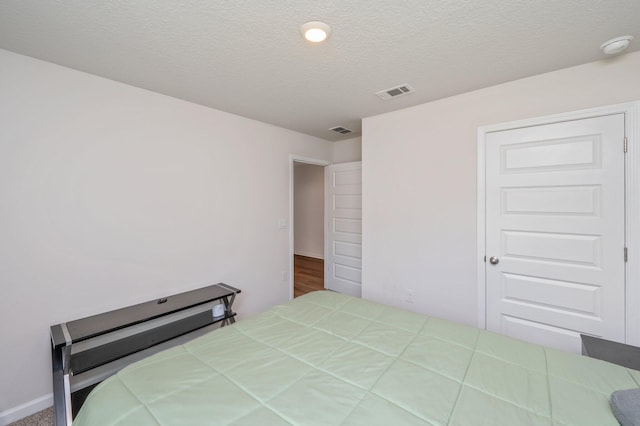 6629 Spyglass Hill Rd, Laurel Hill, FL 32567 - bedroom featuring a textured ceiling and visible vents