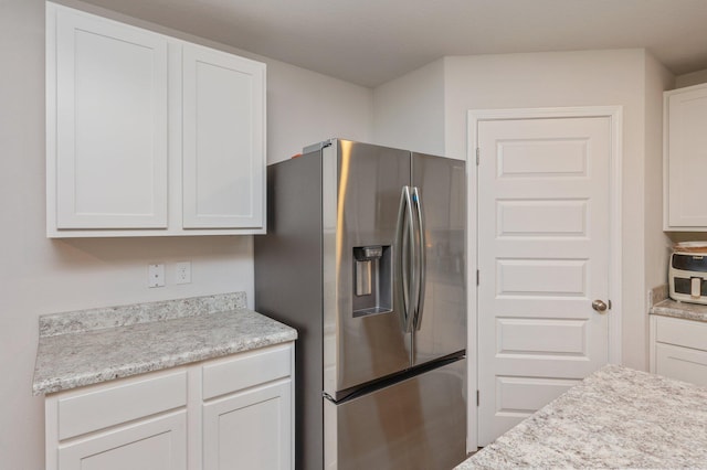 6629 Spyglass Hill Rd, Laurel Hill, FL 32567 - kitchen featuring stainless steel refrigerator with ice dispenser and white cabinetry