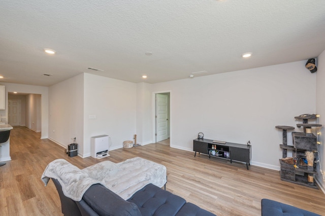 6629 Spyglass Hill Rd, Laurel Hill, FL 32567 - living room featuring light wood-style floors, a textured ceiling, recessed lighting, baseboards, and visible vents