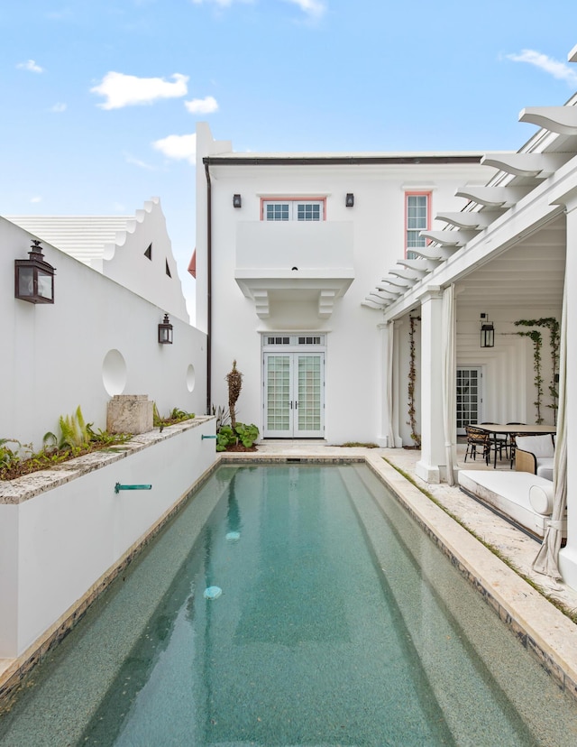 30 N Charles St, Inlet Beach, FL 32461 - back of property featuring a pergola, a patio area, an outdoor pool, stucco siding, and french doors