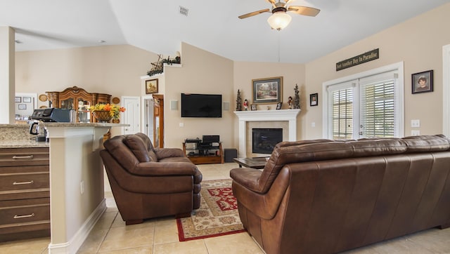 174 Mango Ln, Freeport, FL 32439 - living area featuring a glass covered fireplace, light tile patterned floors, ceiling fan, lofted ceiling, and visible vents