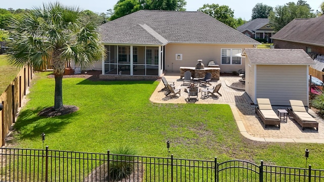 174 Mango Ln, Freeport, FL 32439 - back of property featuring a lawn, a fenced backyard, an outdoor structure, a patio, and a sunroom