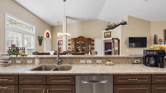 174 Mango Ln, Freeport, FL 32439 - kitchen with dishwasher, vaulted ceiling, light stone counters, and dark brown cabinets