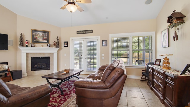 174 Mango Ln, Freeport, FL 32439 - living room featuring lofted ceiling, a tile fireplace, light tile patterned floors, baseboards, and ceiling fan