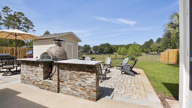 174 Mango Ln, Freeport, FL 32439 - view of patio with an outdoor kitchen, a fenced backyard, and outdoor wet bar