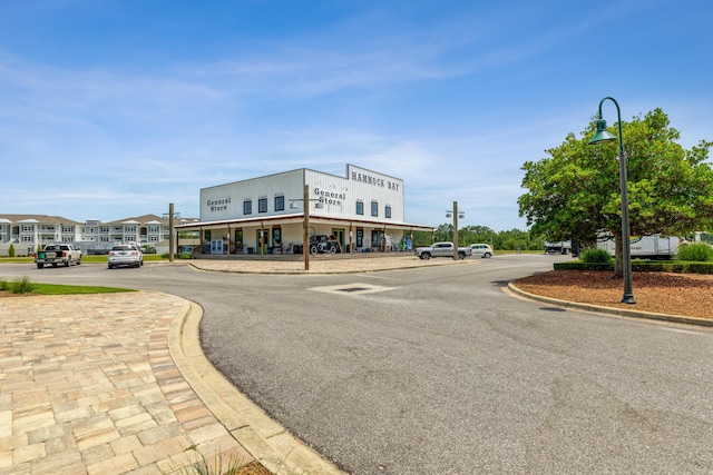 174 Mango Ln, Freeport, FL 32439 - view of asphalt road featuring street lights and curbs