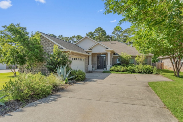9124 Orlando Ave, Navarre, FL 32566 - view of front facade with brick siding, a garage, and driveway