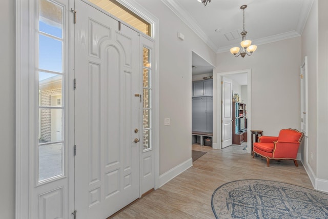 9124 Orlando Ave, Navarre, FL 32566 - entryway with a chandelier, crown molding, baseboards, and light wood-type flooring