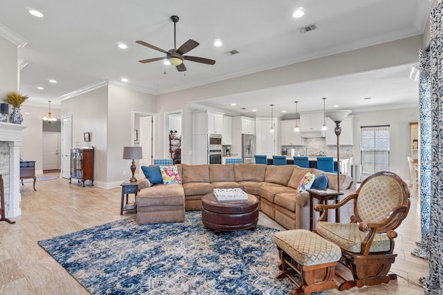 9124 Orlando Ave, Navarre, FL 32566 - living area with a ceiling fan, a fireplace, recessed lighting, crown molding, and baseboards