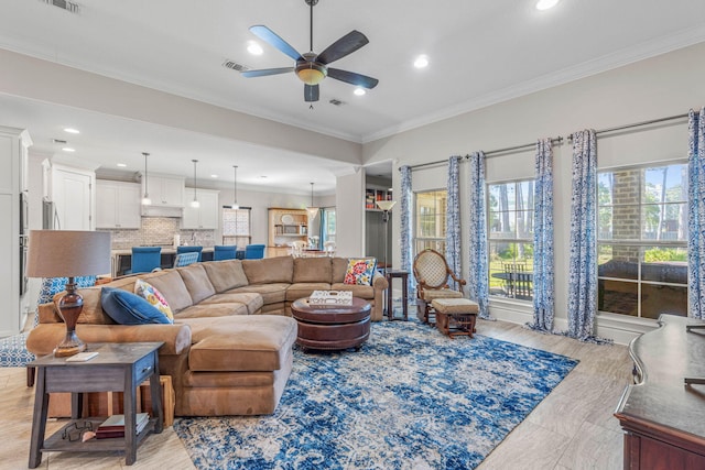 9124 Orlando Ave, Navarre, FL 32566 - living room featuring a ceiling fan, recessed lighting, and ornamental molding