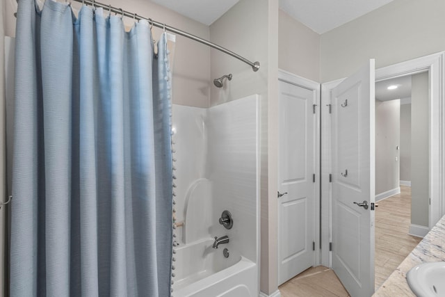 9124 Orlando Ave, Navarre, FL 32566 - bathroom featuring shower / tub combo, a sink, and wood finished floors
