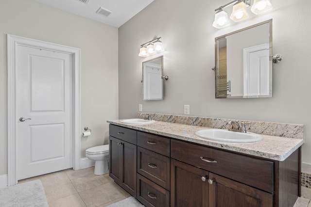 9124 Orlando Ave, Navarre, FL 32566 - full bathroom featuring double vanity, toilet, and tile patterned flooring