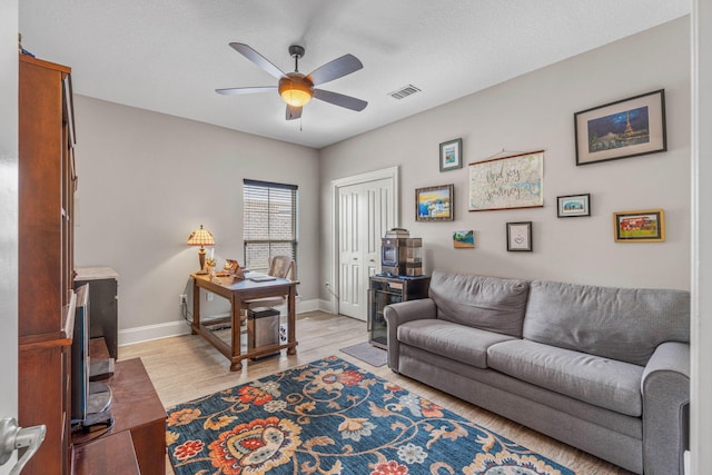 9124 Orlando Ave, Navarre, FL 32566 - living area with ceiling fan, light wood-type flooring, and baseboards