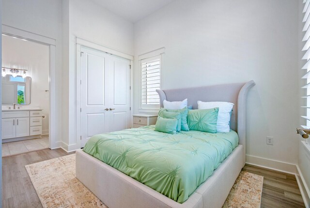 40 Cote D Azur Dr, Santa Rosa Beach, FL 32459 - bedroom featuring light wood-type flooring, ensuite bathroom, a closet, and a sink