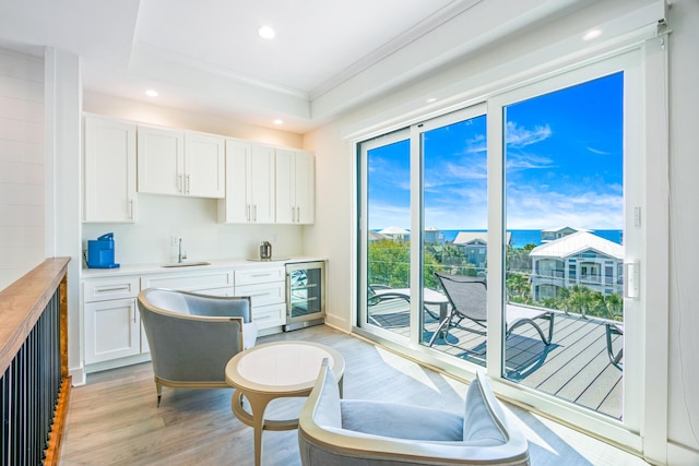 40 Cote D Azur Dr, Santa Rosa Beach, FL 32459 - kitchen with light wood-type flooring, recessed lighting, white cabinets, and wine cooler