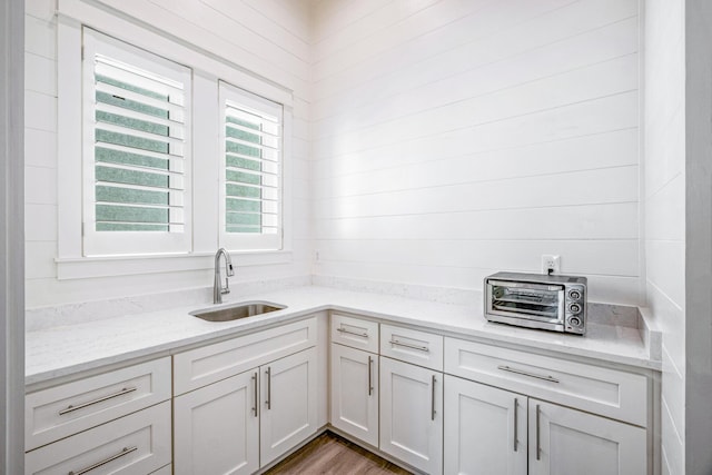 40 Cote D Azur Dr, Santa Rosa Beach, FL 32459 - kitchen with white cabinets, a toaster, light stone countertops, and a sink