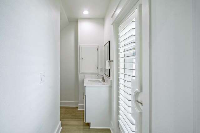 40 Cote D Azur Dr, Santa Rosa Beach, FL 32459 - hallway with baseboards, light wood finished floors, recessed lighting, and a sink