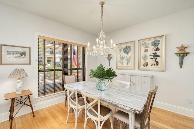 16 Kingfish St, Santa Rosa Beach, FL 32459 - dining space with baseboards, light wood-style flooring, and a chandelier