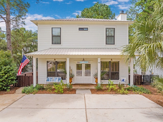 16 Kingfish St, Santa Rosa Beach, FL 32459 - view of front facade with a porch, a chimney, metal roof, and fence