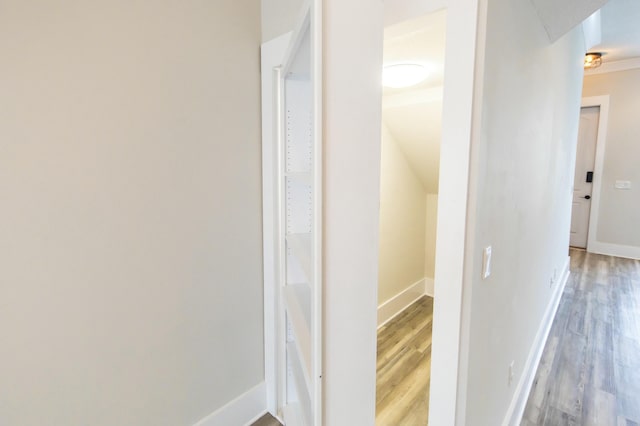 hall with wood finished floors and baseboards
