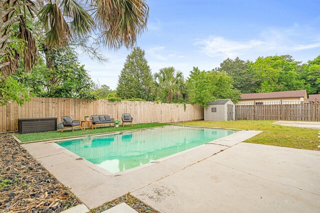 1017 Revere Dr, Pensacola, FL 32505 - view of swimming pool featuring a lawn, a storage unit, a fenced backyard, and a patio area