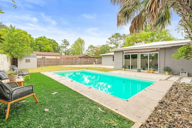 1017 Revere Dr, Pensacola, FL 32505 - view of pool with an outdoor structure, a fenced backyard, a yard, a storage unit, and a patio area