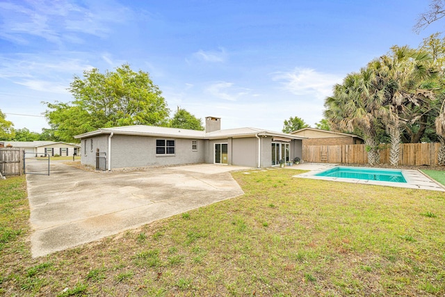 1017 Revere Dr, Pensacola, FL 32505 - rear view of house featuring a patio, a fenced in pool, a chimney, a lawn, and a fenced backyard