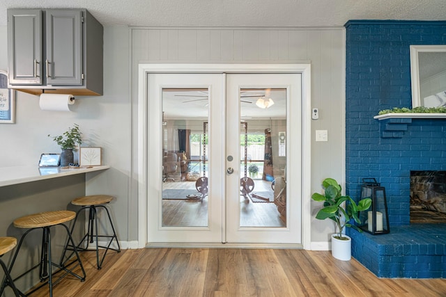 1017 Revere Dr, Pensacola, FL 32505 - doorway featuring baseboards, wood finished floors, french doors, and a brick fireplace