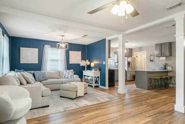 1017 Revere Dr, Pensacola, FL 32505 - living area with visible vents, ornate columns, ceiling fan, and light wood-style flooring