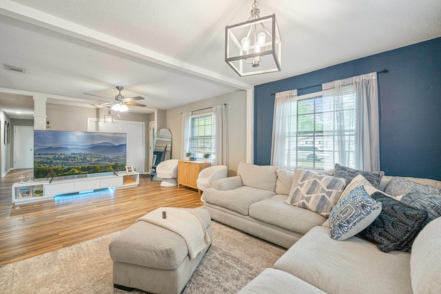 1017 Revere Dr, Pensacola, FL 32505 - living area featuring visible vents, wood finished floors, and ceiling fan with notable chandelier