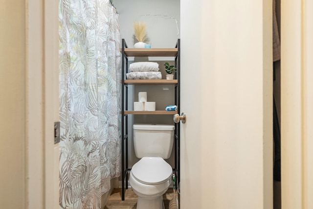 1017 Revere Dr, Pensacola, FL 32505 - bathroom featuring wood finished floors, toilet, and a shower with curtain