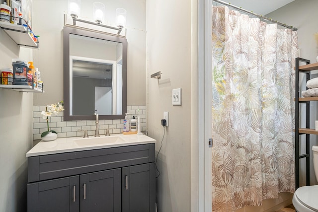 1017 Revere Dr, Pensacola, FL 32505 - bathroom with a shower with shower curtain, toilet, vanity, and decorative backsplash