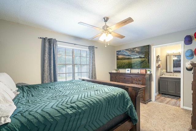 1017 Revere Dr, Pensacola, FL 32505 - bedroom with a sink, a ceiling fan, ensuite bath, and light wood-style floors
