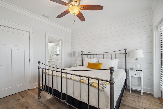 116 Riviera Dr, Panama City Beach, FL 32413 - bedroom featuring visible vents, a ceiling fan, wood finished floors, ensuite bath, and ornamental molding