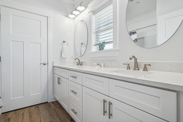 116 Riviera Dr, Panama City Beach, FL 32413 - full bathroom with wood finished floors, a sink, and double vanity