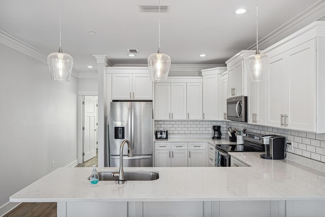 116 Riviera Dr, Panama City Beach, FL 32413 - kitchen featuring crown molding, appliances with stainless steel finishes, baseboards, and a sink