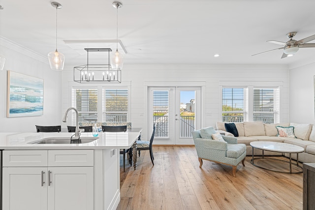 116 Riviera Dr, Panama City Beach, FL 32413 - interior space featuring plenty of natural light, light wood finished floors, a sink, crown molding, and open floor plan