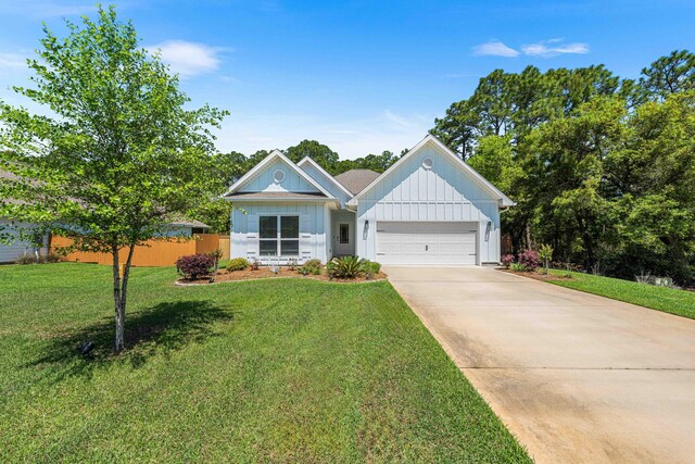 modern farmhouse style home with board and batten siding, fence, a garage, driveway, and a front yard