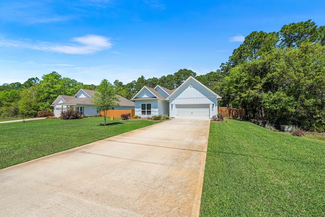 view of front of house with a front yard, driveway, and a garage