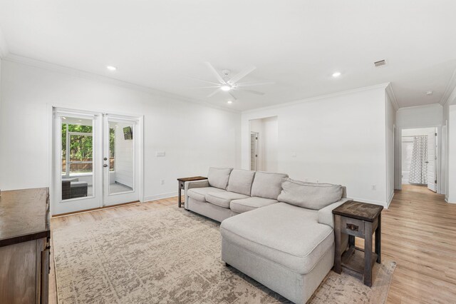 living room with light wood-style flooring, ornamental molding, baseboards, a ceiling fan, and french doors