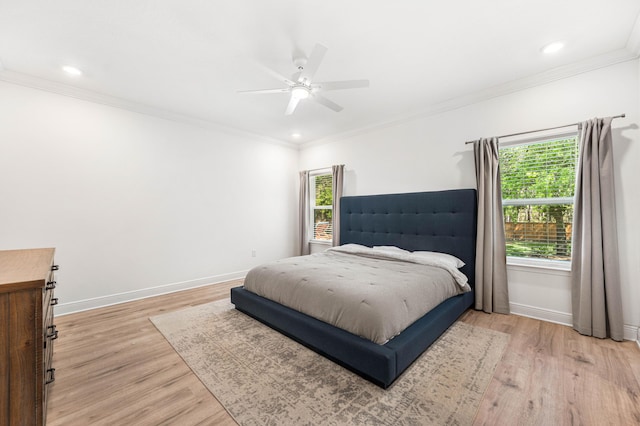 bedroom with baseboards, recessed lighting, light wood-style floors, and crown molding