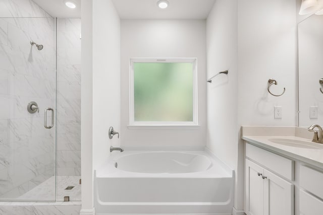 full bath featuring a garden tub, a shower stall, and vanity