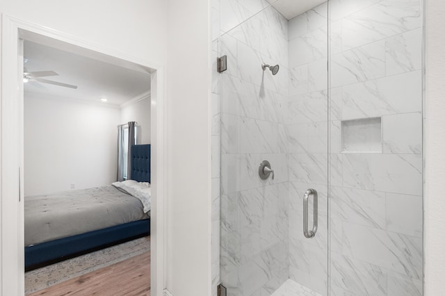 full bathroom with ornamental molding, a stall shower, ceiling fan, and connected bathroom