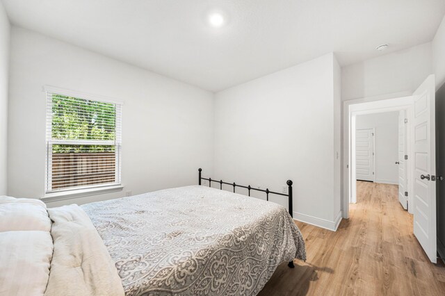 bedroom featuring light wood-style flooring and baseboards