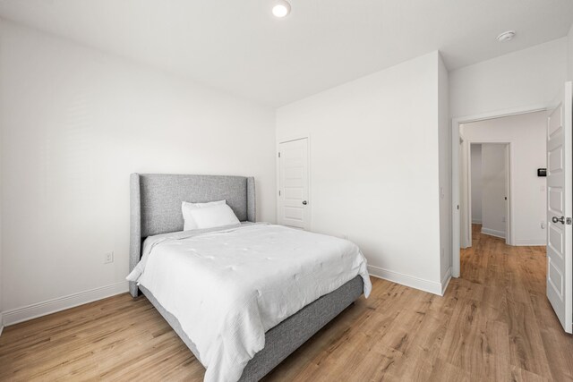 bedroom featuring baseboards, recessed lighting, and light wood finished floors