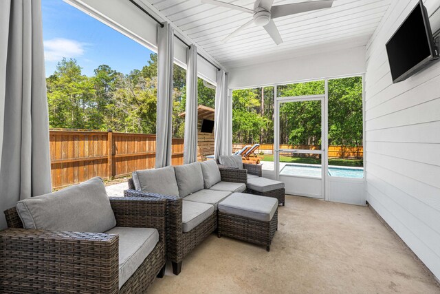 sunroom / solarium with a ceiling fan and an outdoor hangout area