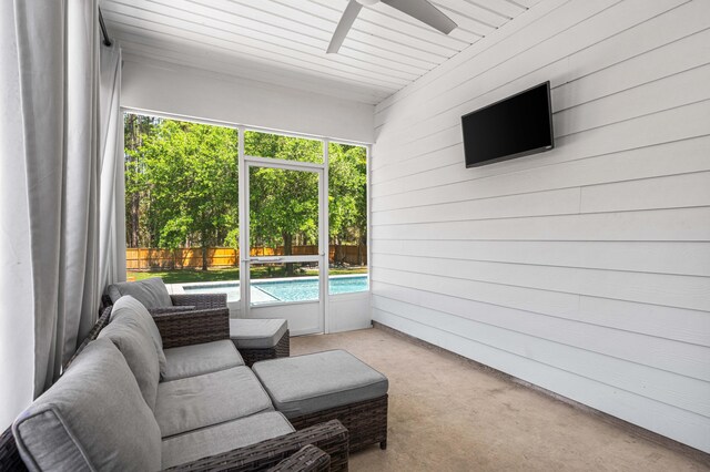 sunroom / solarium with a ceiling fan