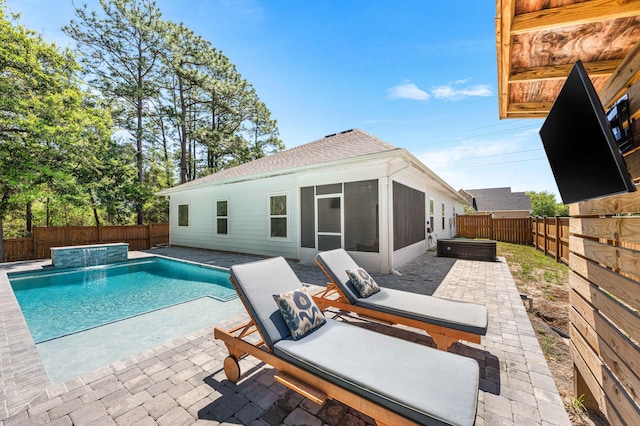 back of property featuring a patio, a fenced backyard, a sunroom, and a jacuzzi